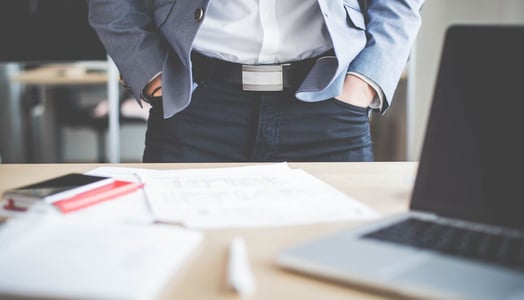 businessman-standing-in-his-office